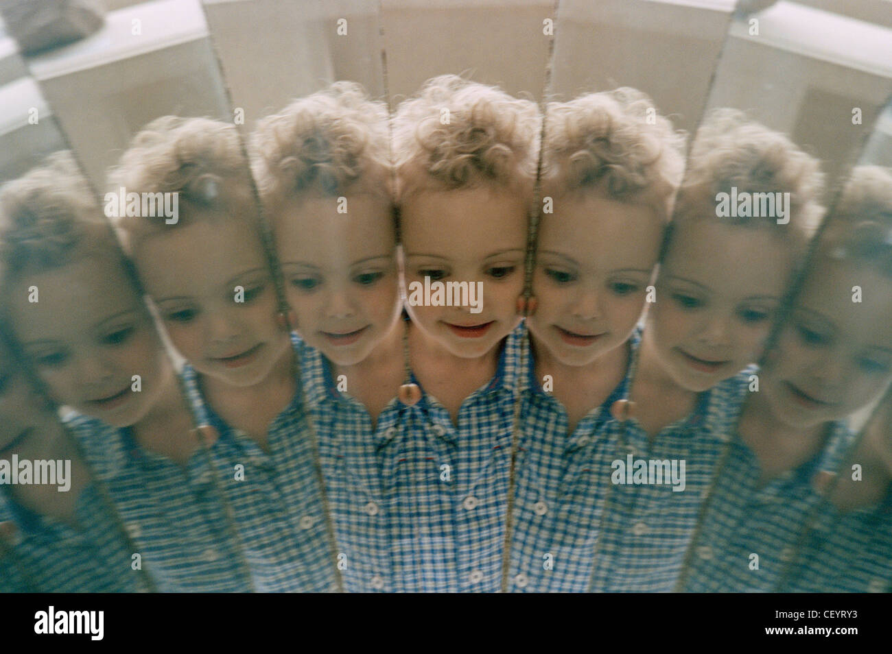 Male child reflected in mirrors Stock Photo