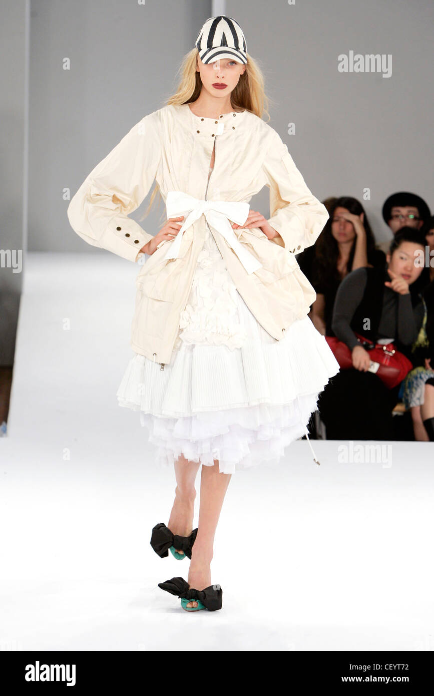 Nathan Jenden London Ready to Wear Spring Summer Striped monochrome cap, pale pink coat ribbon tie, over puffball ruffled gown, Stock Photo