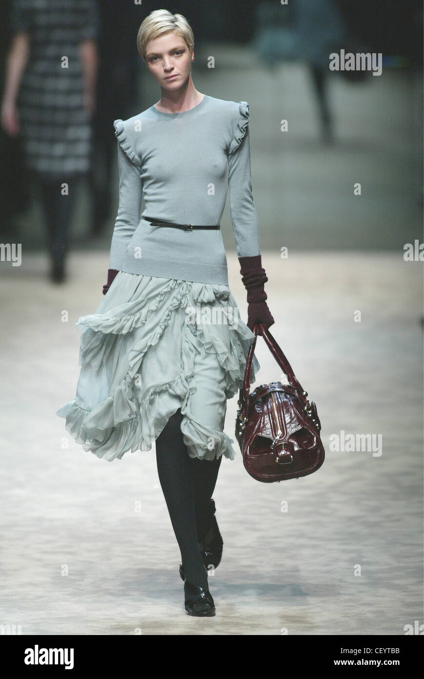 Burberry Ready to Wear Milan A W Italian model Mariacarla Boscono wearing a  pale blue sweater frills on the shoulders and a Stock Photo - Alamy