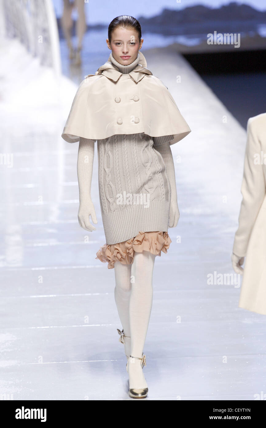 princess polly baby blue dress Blu Girl Milan Ready to Wear Autumn Winter Model wearing short white cape,  white cable knit dress, white knitted gloves Stock Photo
