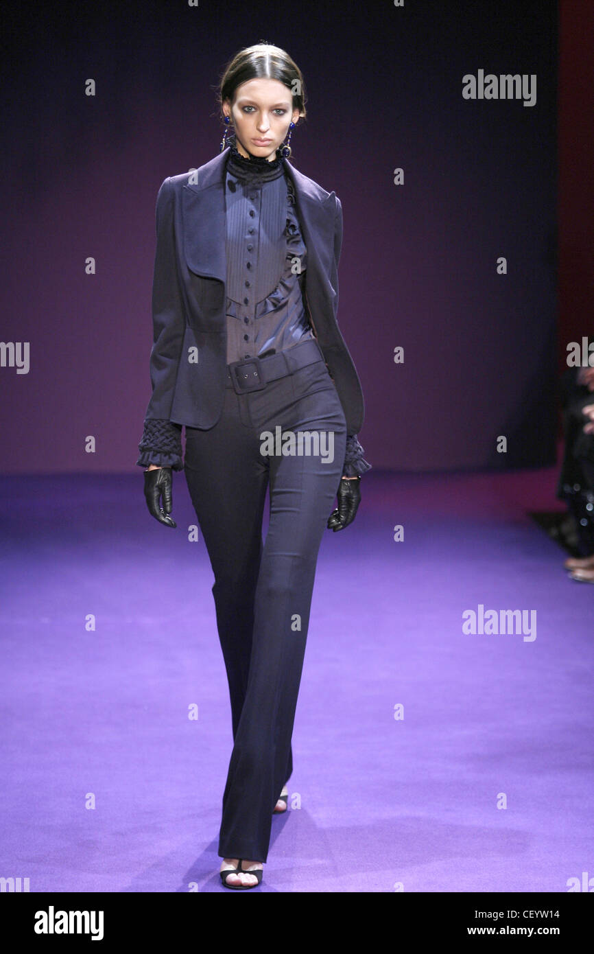 Andrew Gn Paris Ready to Wear Autumn Winter Model wearing a blue single breasted jacket, blue blouse ruffles, and blue narrow Stock Photo