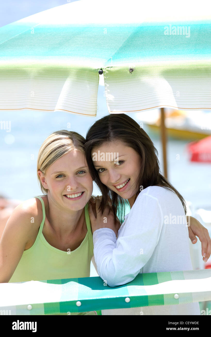 Females sitting in the shade under a parasol Stock Photo