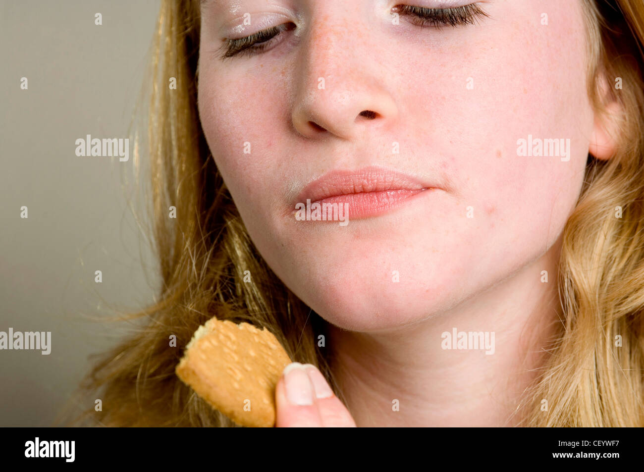 Female eating a digestive biscuit Stock Photo Alamy