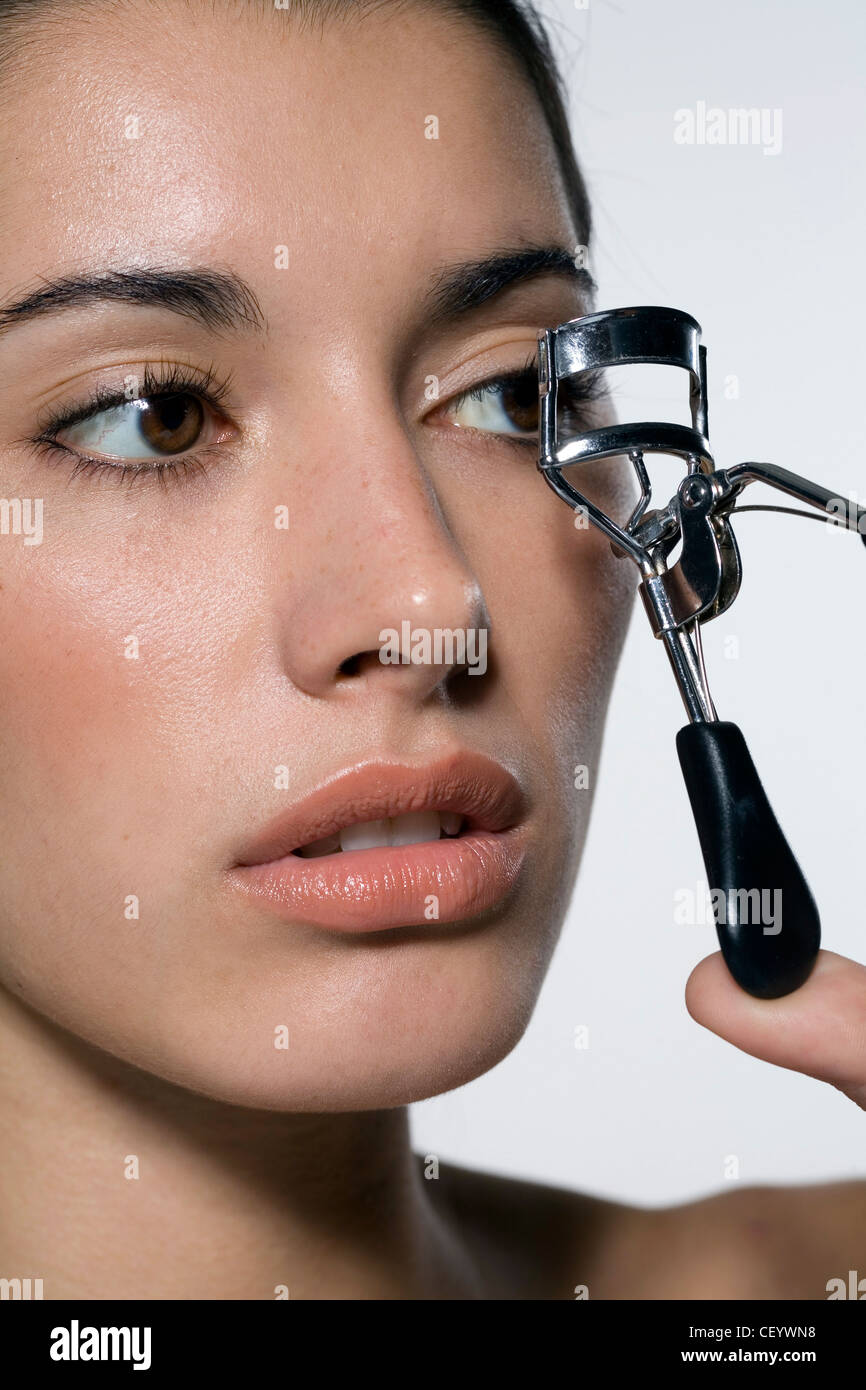 Female using an eyelash curler Stock Photo Alamy