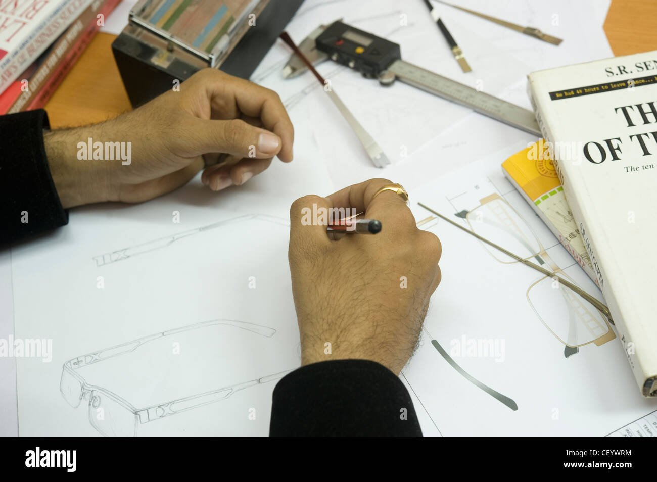 Optics designer drawing new design spectacles for mass manufacturing