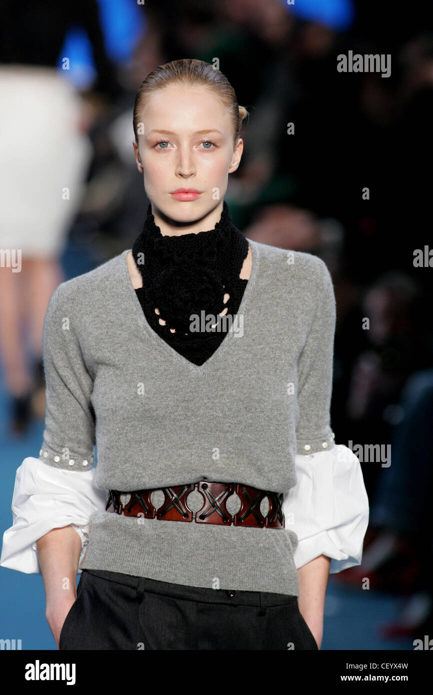 Grey V neck sweater blouse with brown belt Stock Photo - Alamy