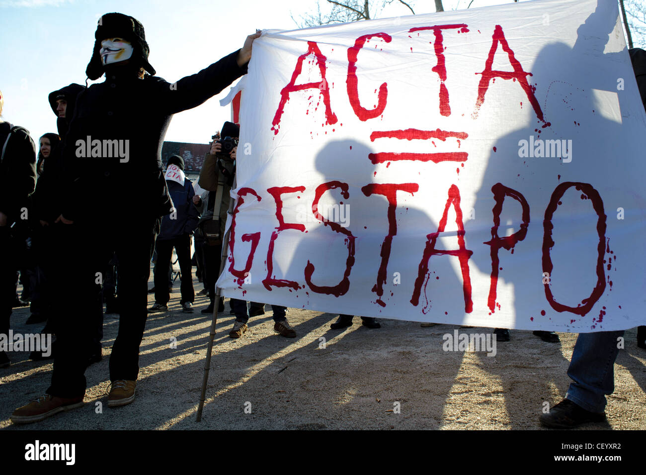 Protesters hold up a banner that reads 'ACTA = GESTAPO' on protests against the Anti Counterfiting Trade Agreement. Stock Photo