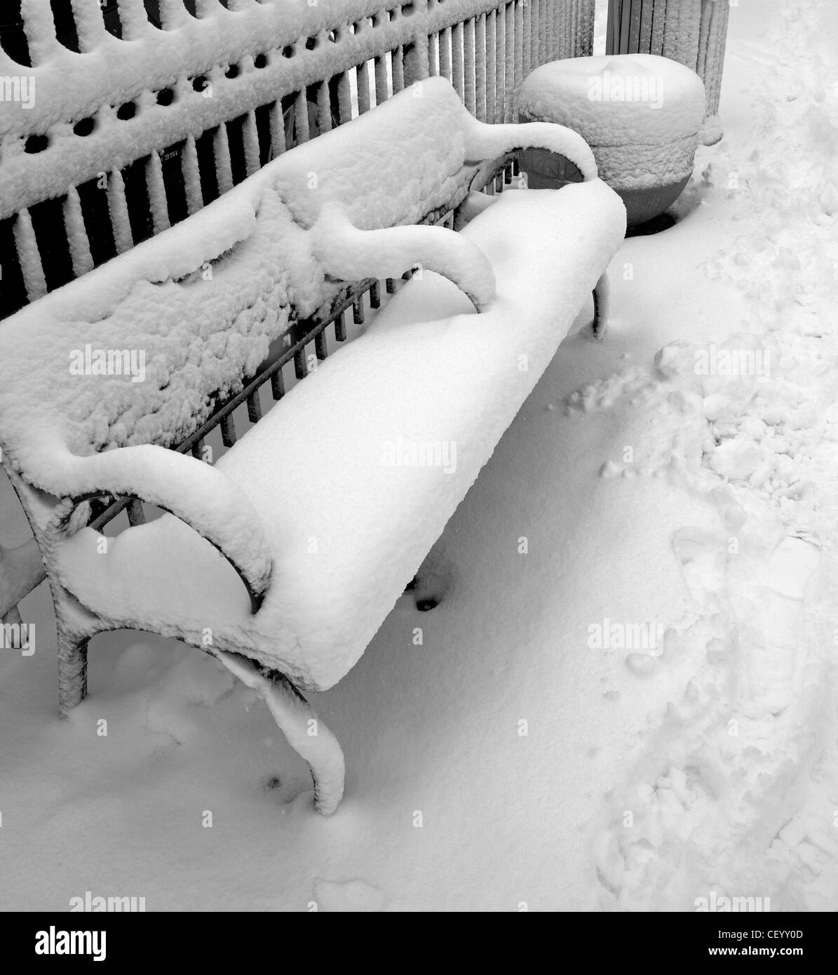 A bench is covered in snow after a storm in Milwaukee, Wisconsin. Stock Photo