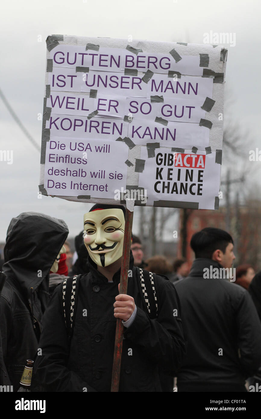 A protester wearing a Guy Fawkes mask is protesting against the Anti-Counterfeiting Trade Agreement (ACTA) in Leipzig, Germany. Stock Photo