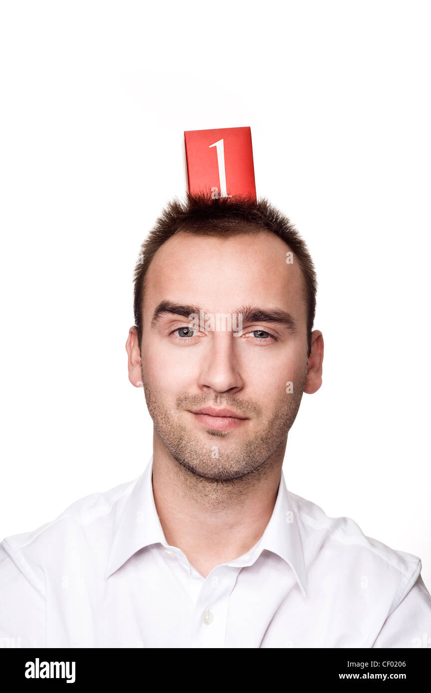 young caucasian male with number one on his head, over white background Stock Photo