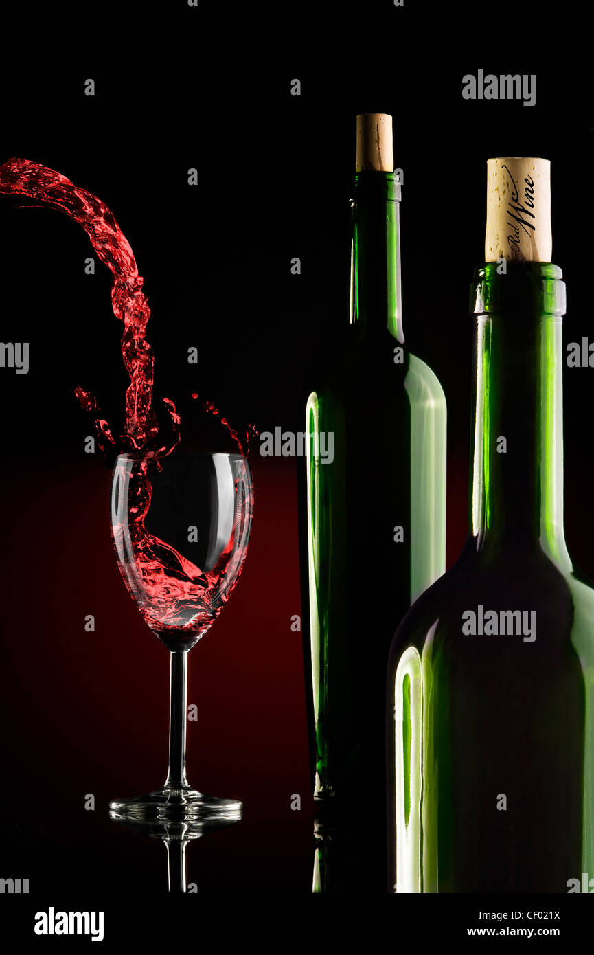 two bottles and a glass of wine over gradient backround Stock Photo