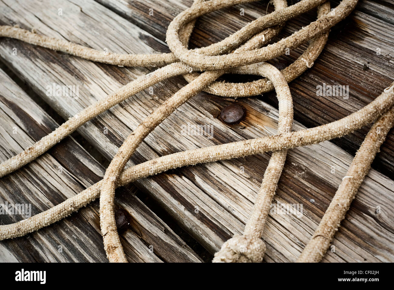 old wooden boards and rusty nails with rope on Stock Photo