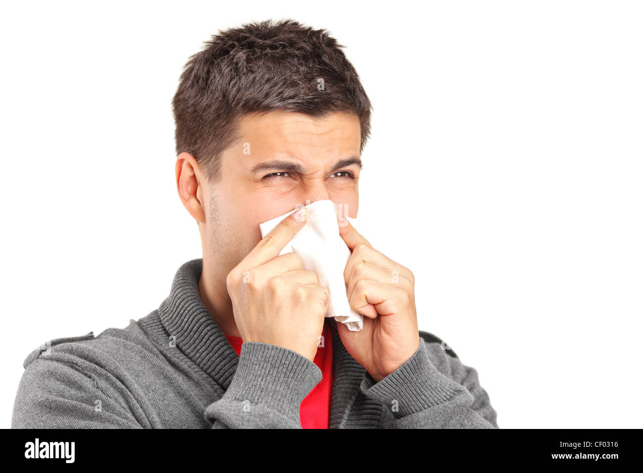 Infected man blowing his nose in tissue paper because of being ill
