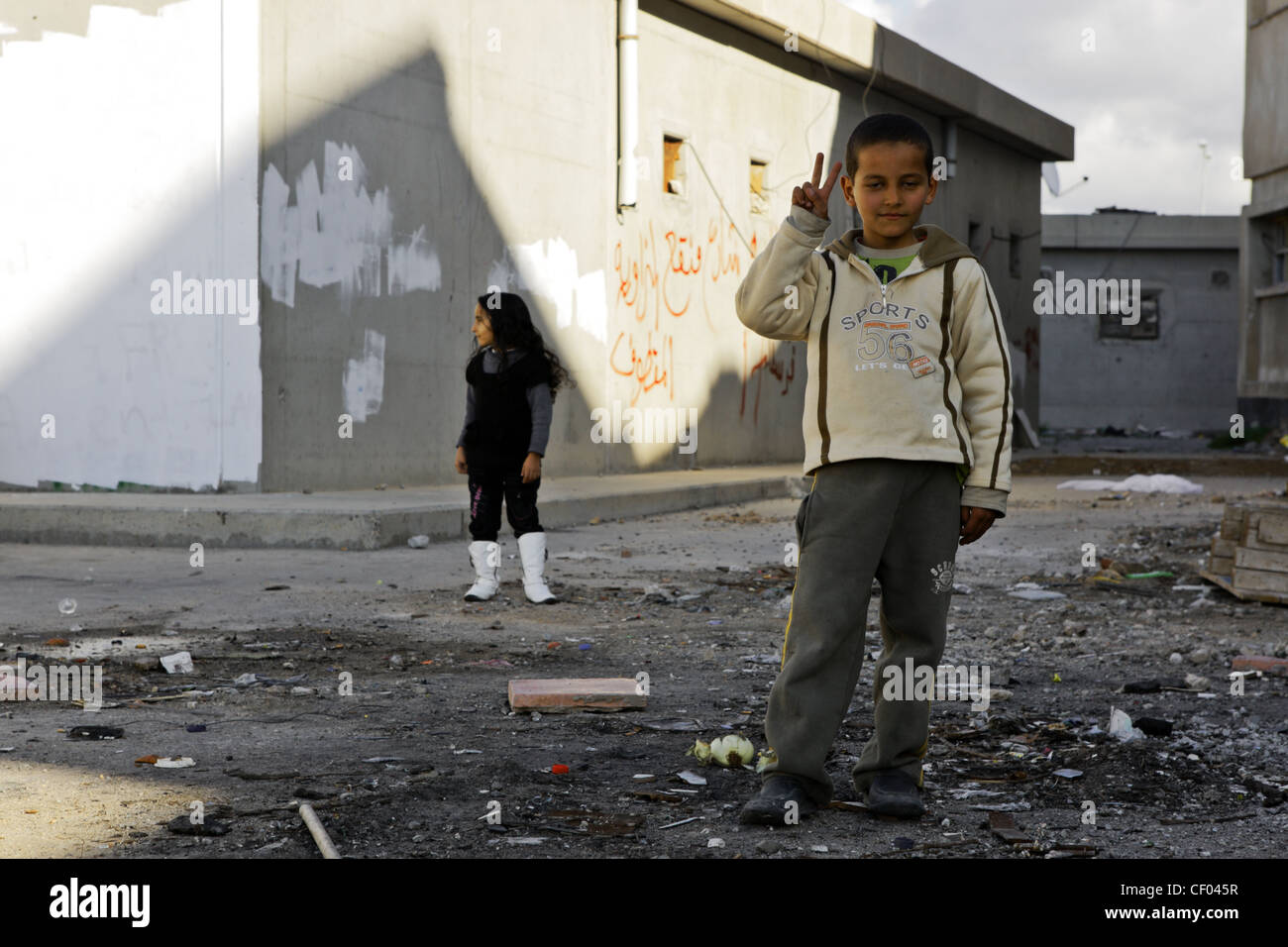 Young Libyan boy shows victory sign at former Gadaffi compound of Bab al-Azizia in Tripoli, Libya Stock Photo