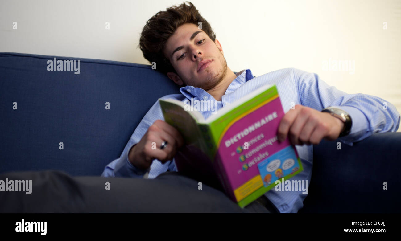 student reading book looking up dictionary Stock Photo