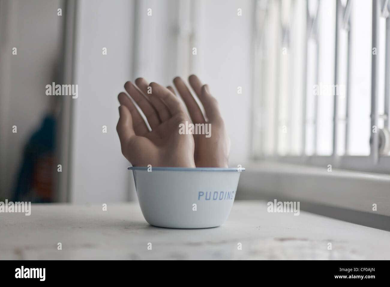 severed hands in and around a pudding bowl Stock Photo Alamy