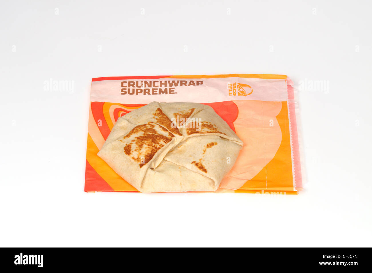 Taco Bell crunchwrap supreme tortilla on wrapper on white background cutout USA Stock Photo