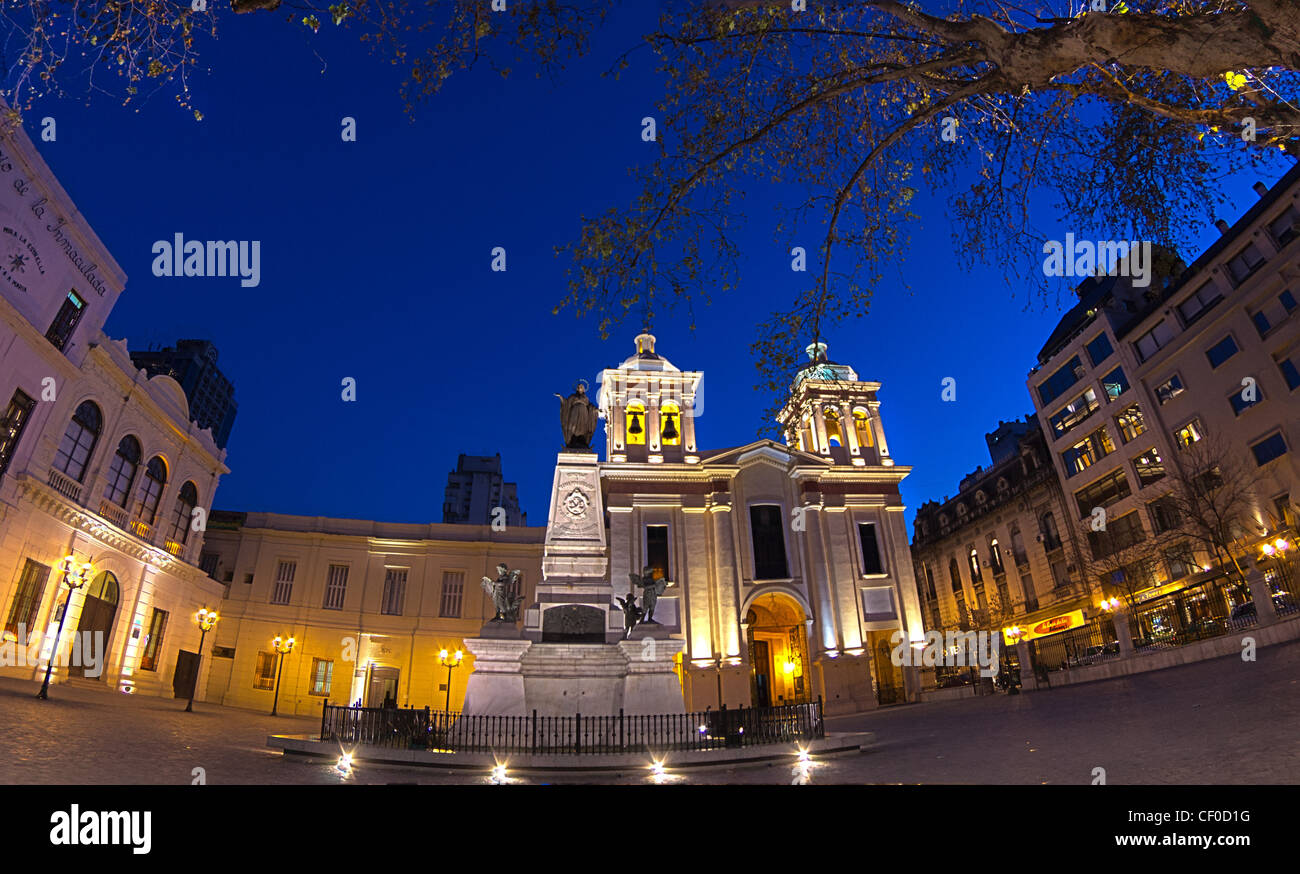 a church exterior in the evening with bright lights and a statue in Cordoba shot in HDR, Argentina Stock Photo