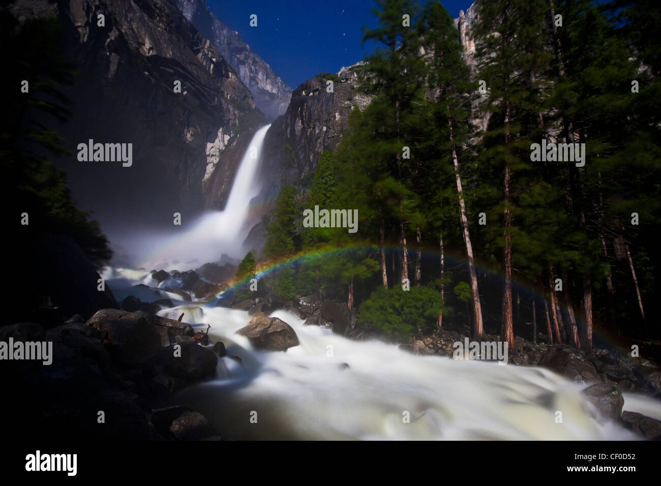 Lunar Rainbow, also known as a moonbow, appears under moonlight at Lower Yosemite Falls - Yosemite National Park, California Stock Photo