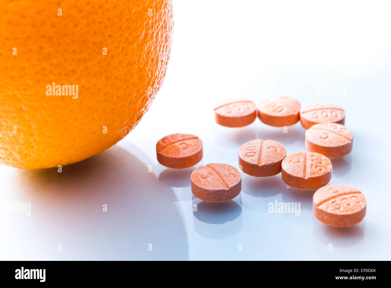Concept image vitamin C on pills and orange fruit Stock Photo