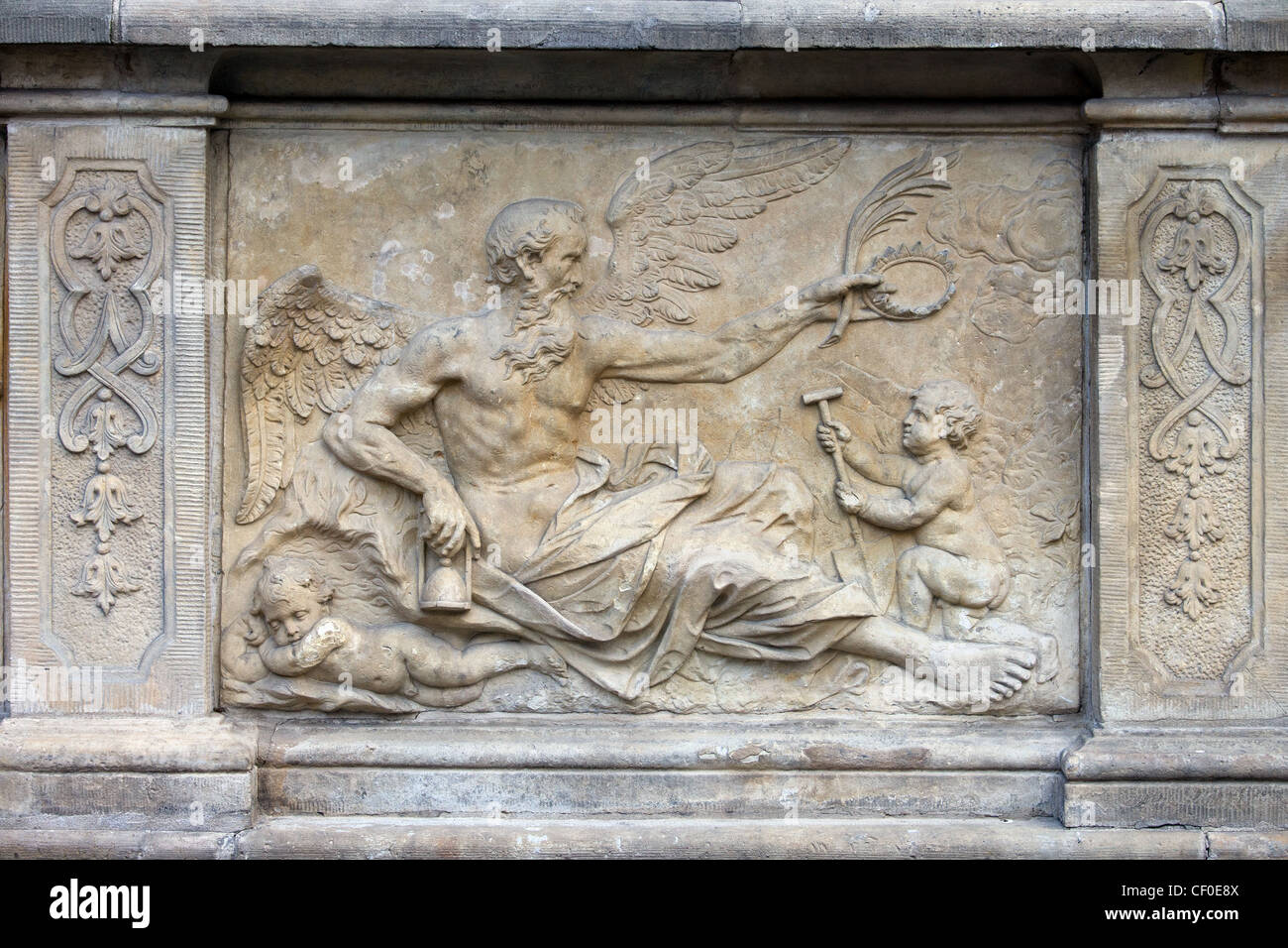 18th century bas-relief of the Chronos (God in Greek mythology, personification of Time) on the historic tenement house terrace. Stock Photo