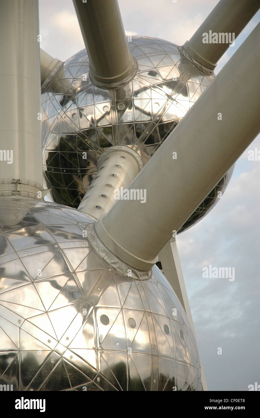 Detail shot of the Atomium. Close up of two of the spheres looking to sky with light alto cumulus clouds. Stock Photo