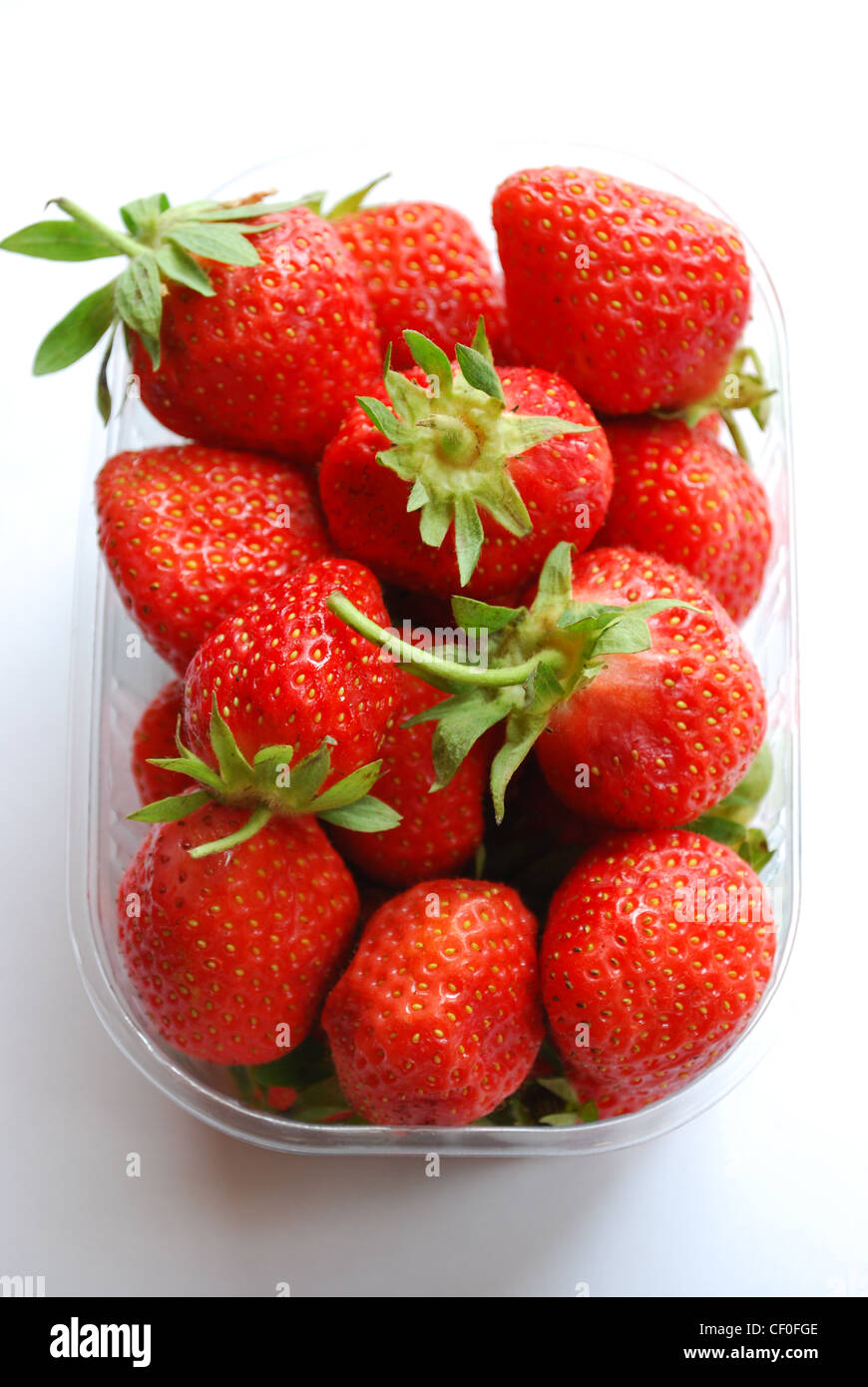 Strawberries in plastic box on white background Stock Photo