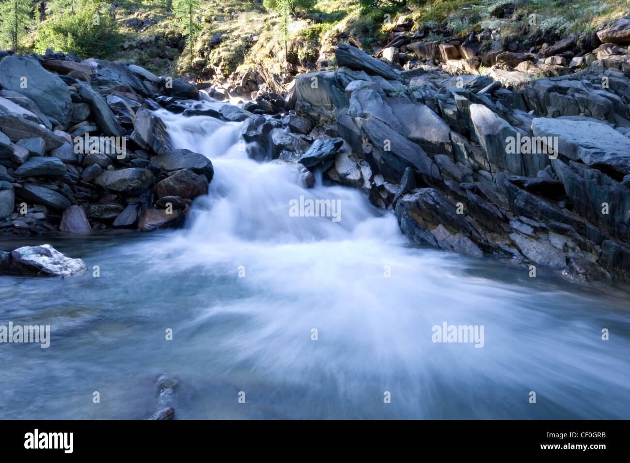Water Rive Flowing stream of water. River in Eastern Sayan mountains. Siberia ...