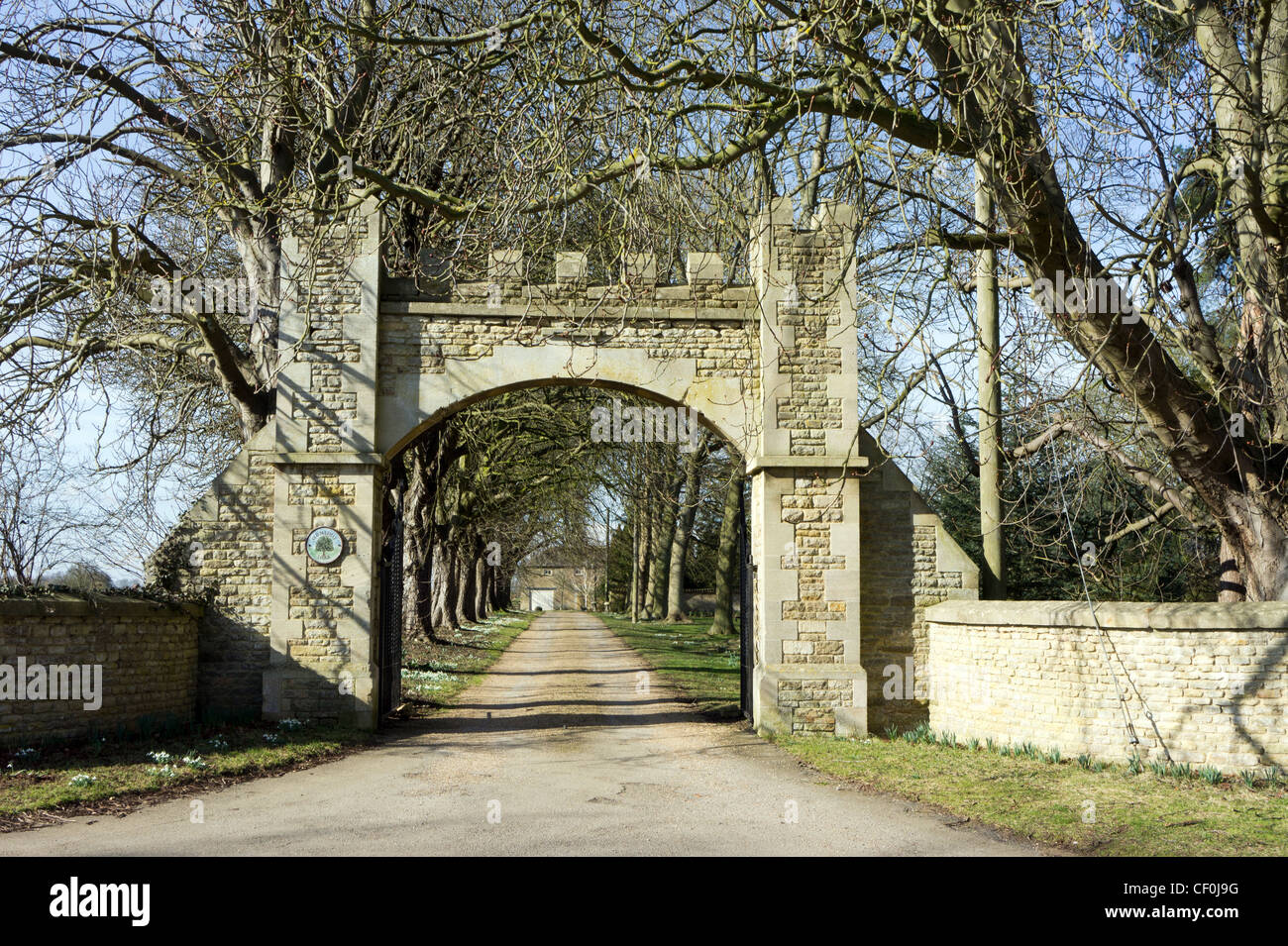 Arched gateway and drive in rural Northamptonshire, England. Stock Photo