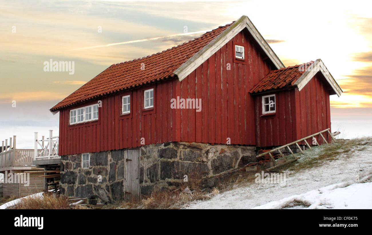 Old traditional wooden deep red (falu) painted cottage in Bohuslan on Swedish West Coast. Stock Photo