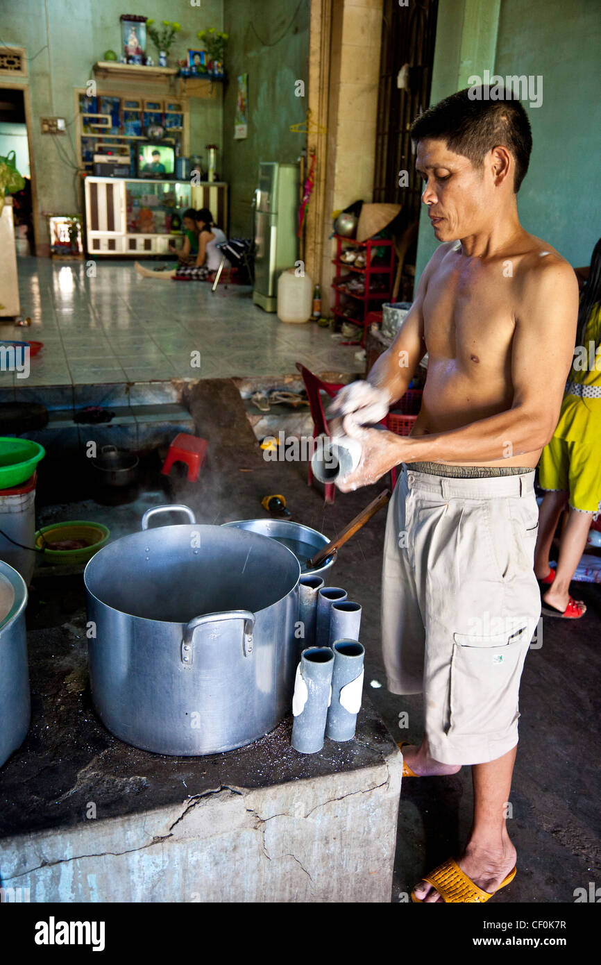 A man making homemade rice noodles in his home kitchen in Vietnam Stock