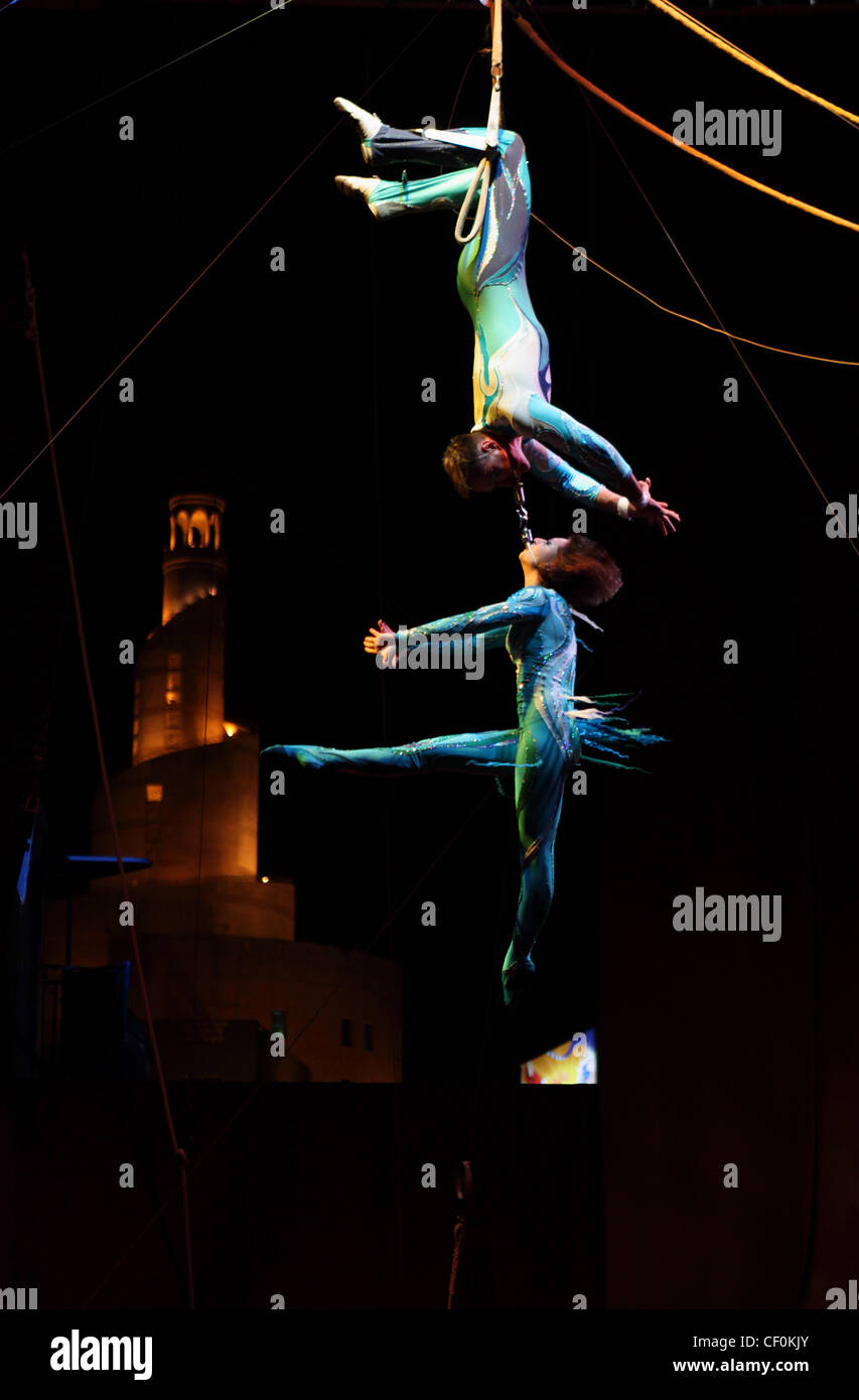 Citcus Acrobats perform for the Doha Spring Festival at a stage in Souq Waqif with the Kassim Darwish mosque as a backdrop. Stock Photo