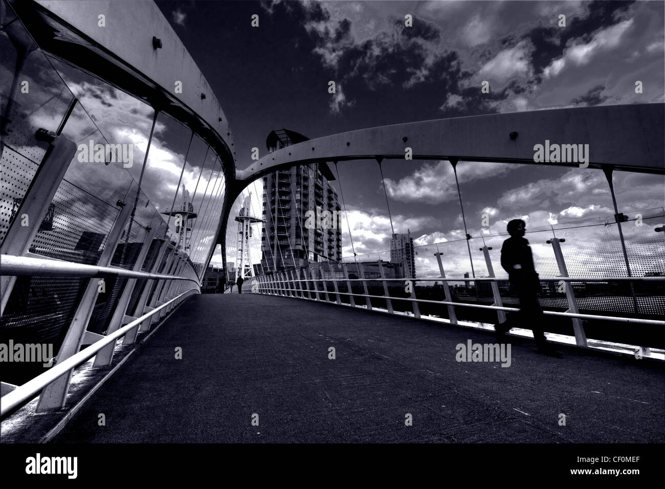 Runner crossing The Salford Quays Lifting Millennium Bridge, Media City UK, Manchester England, M50 3UB Stock Photo