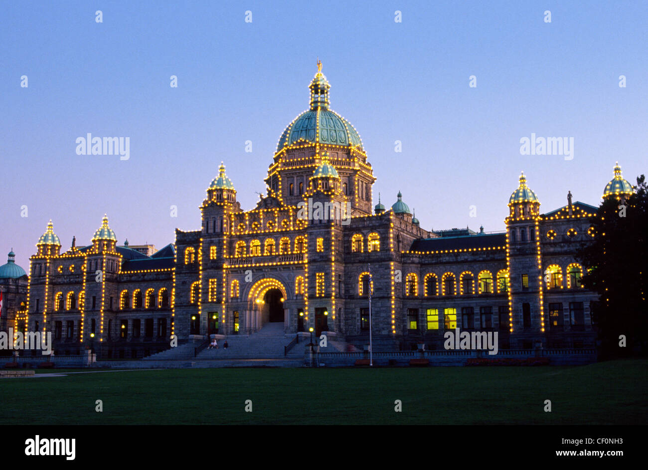 Lights at dusk illuminate the ornate 1890s Parliament Buildings on Vancouver Island in Victoria, the capital city of British Columbia, Canada. Stock Photo