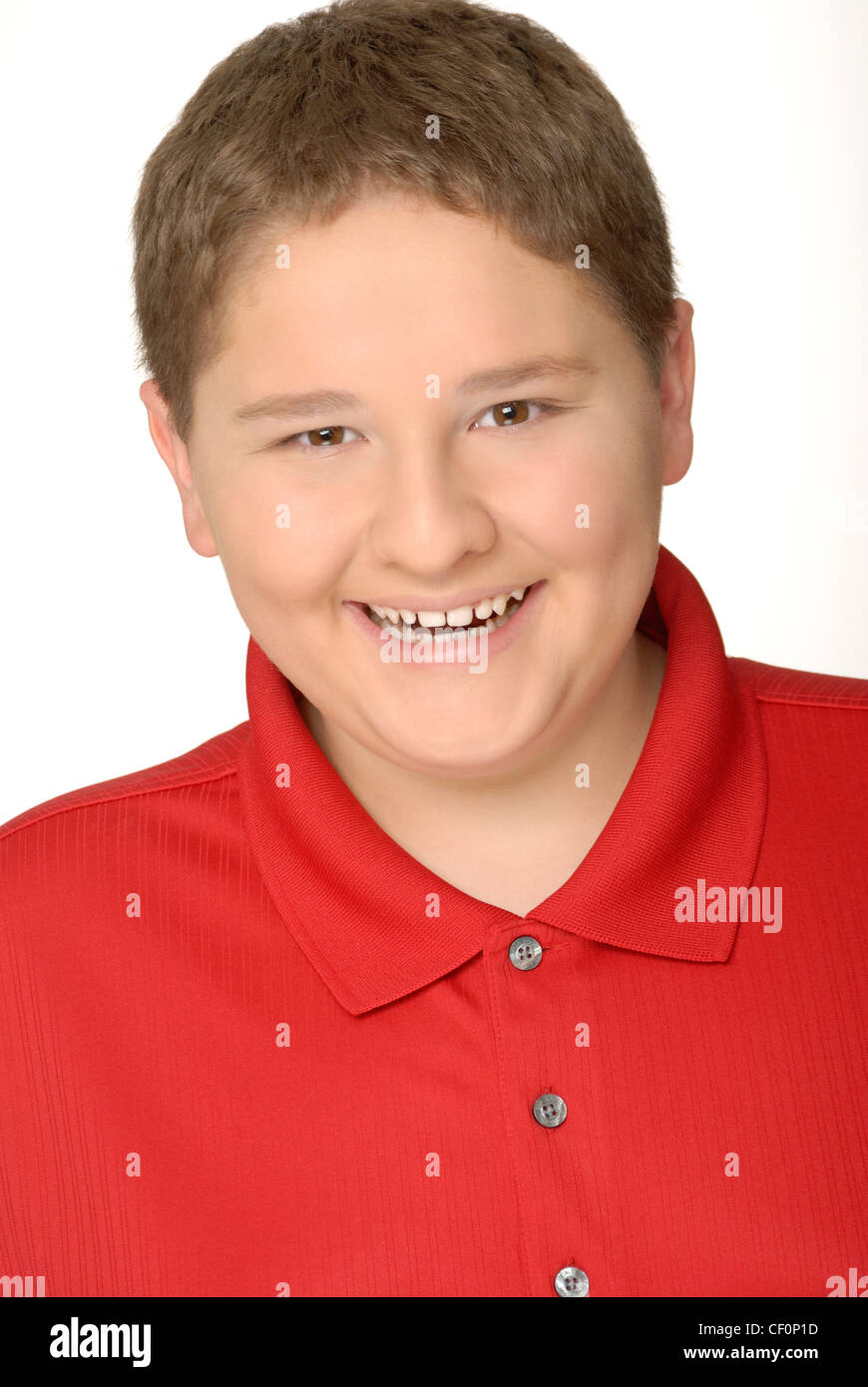 Portrait of a smiling young teen or preteen boy wearing a red shirt
