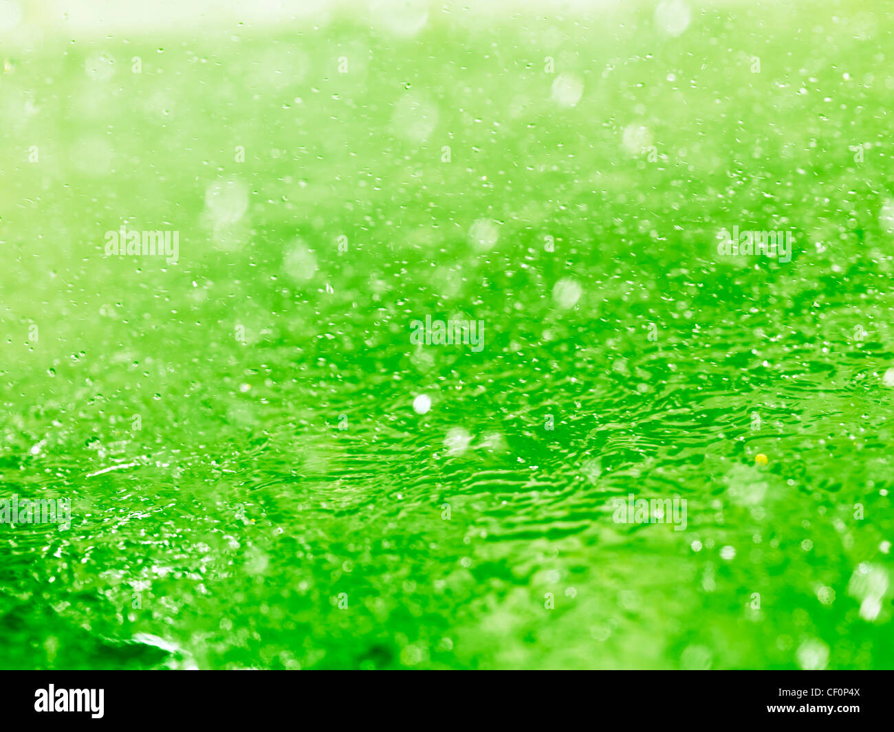 Lime green splashing water closeup abstract background texture Stock Photo