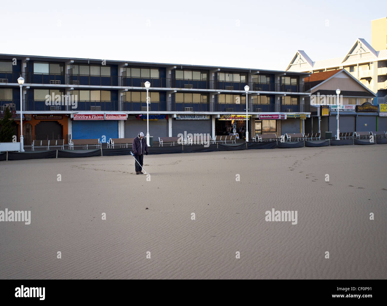 A man with a metal detector on the beach at Ocean City Maryland Stock