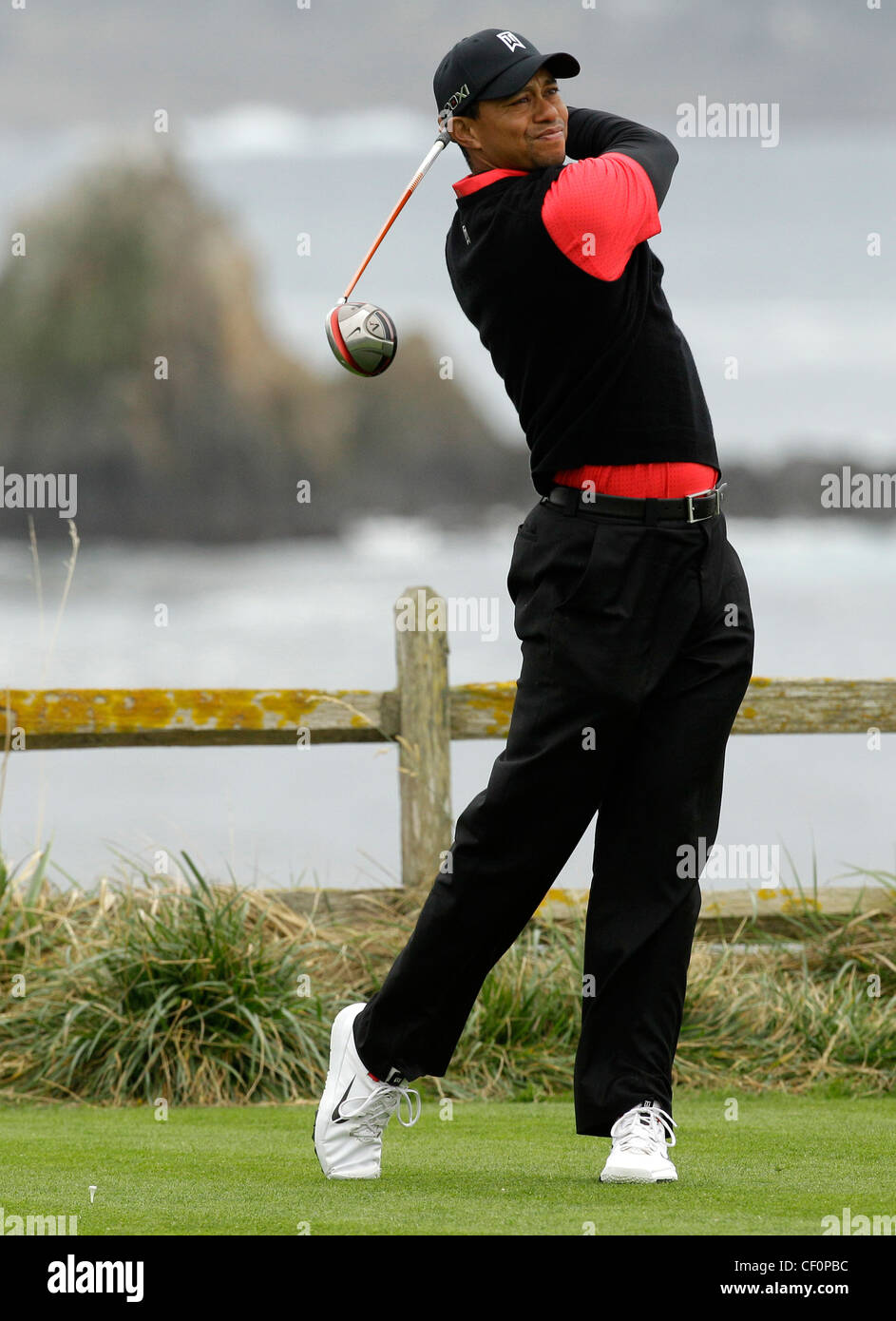 Tiger Woods PGA Golg Golfer swing club Pebble Beach scenic Stock Photo