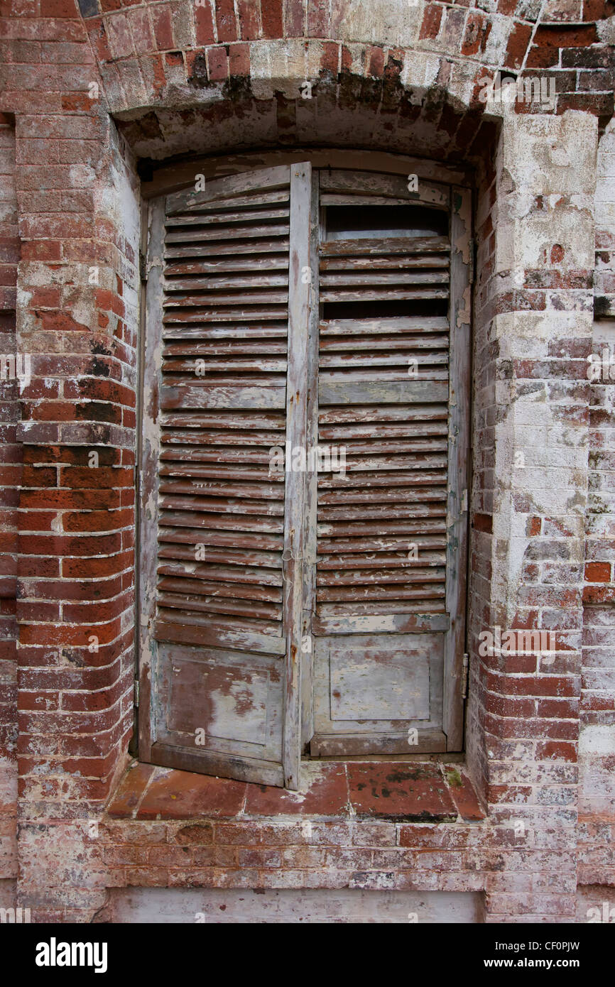 Old Wooden Shutter Window on Rustic Brick Wall Stock Photo - Alamy