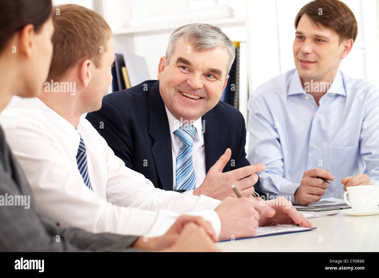 Four people discussing business matters Stock Photo Alamy
