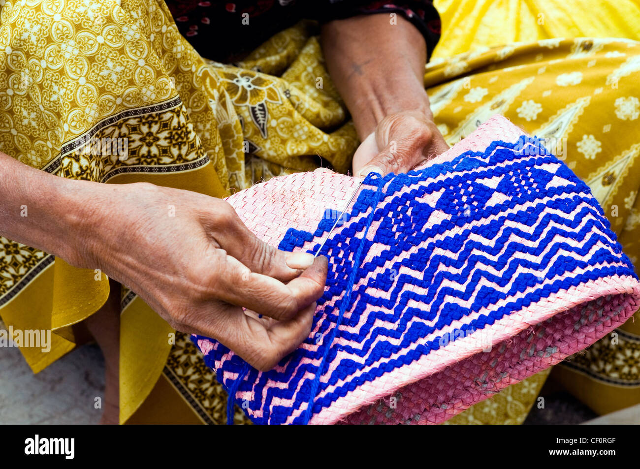 Woman weaving basket waikabubak sumba indonesia Stock Photo