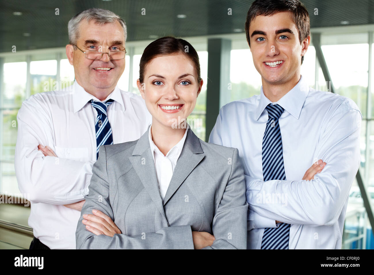 Three smiling business people looking confidently at camera Stock Photo