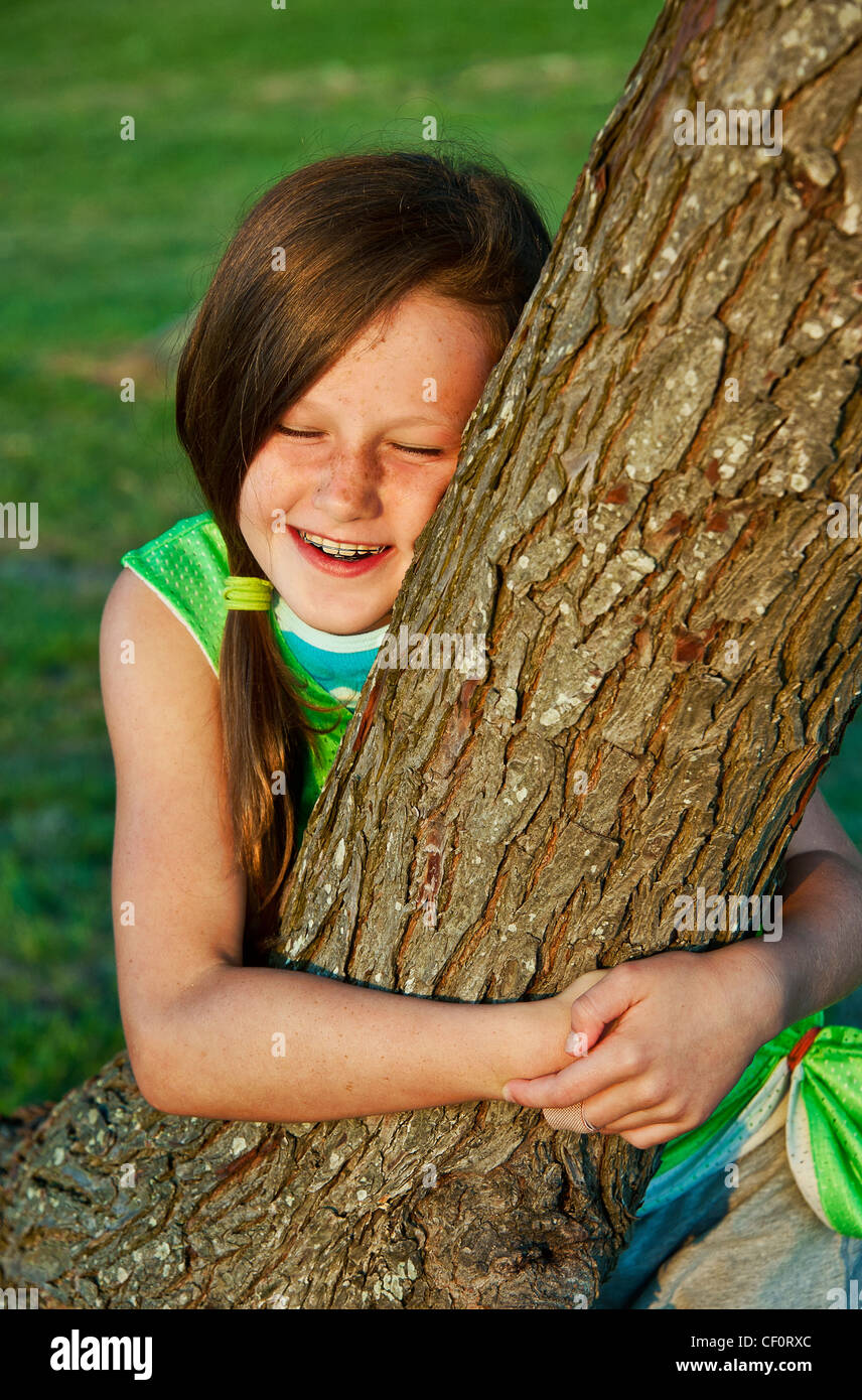 Girl hugging a tree. Stock Photo