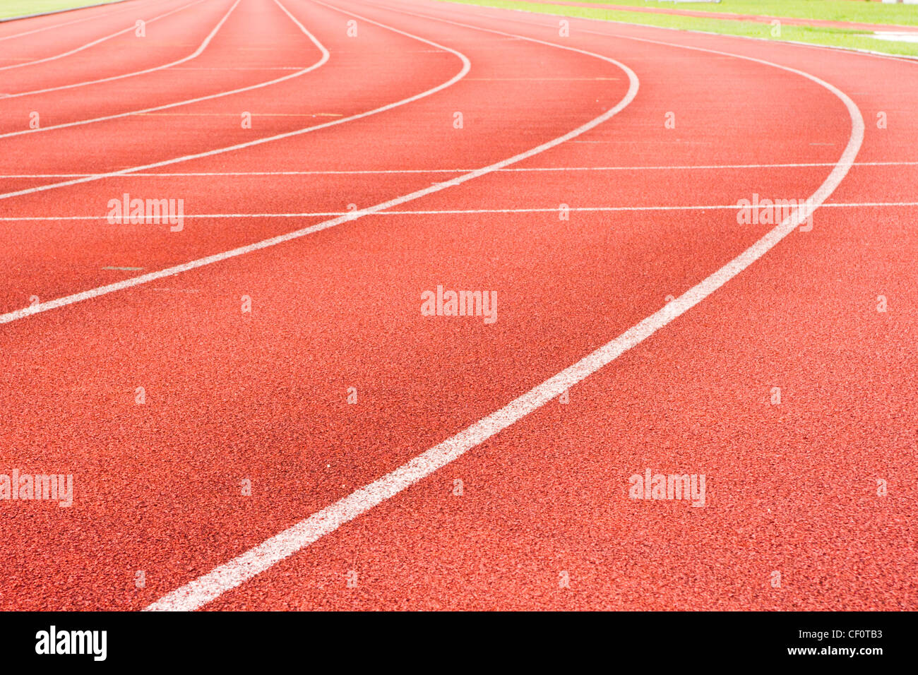 a close up of white line on red racetrack, for sports, concept background. Stock Photo