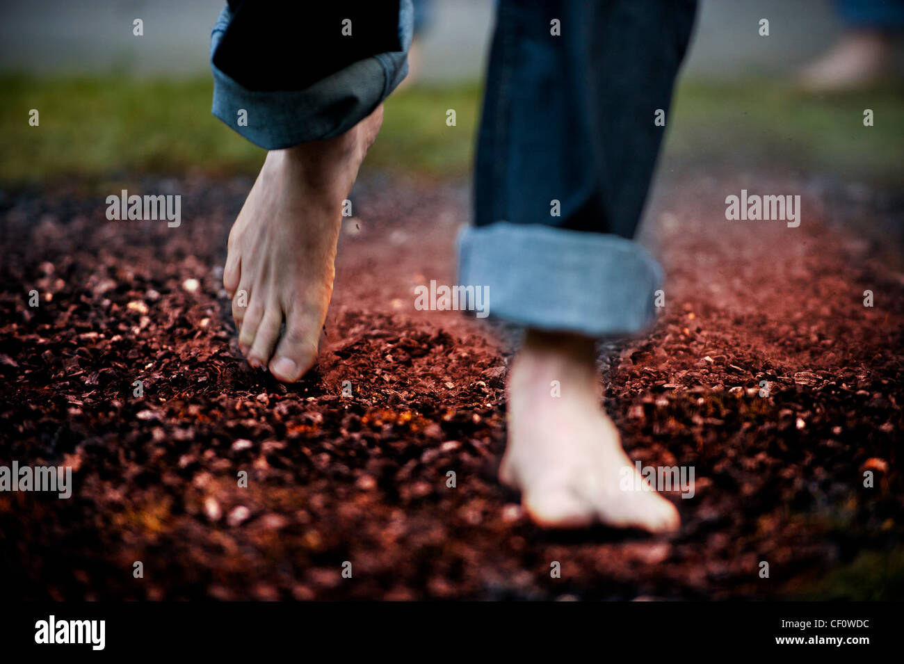 Caucasian male feet walking barefoot on hot coals Stock Photo Alamy