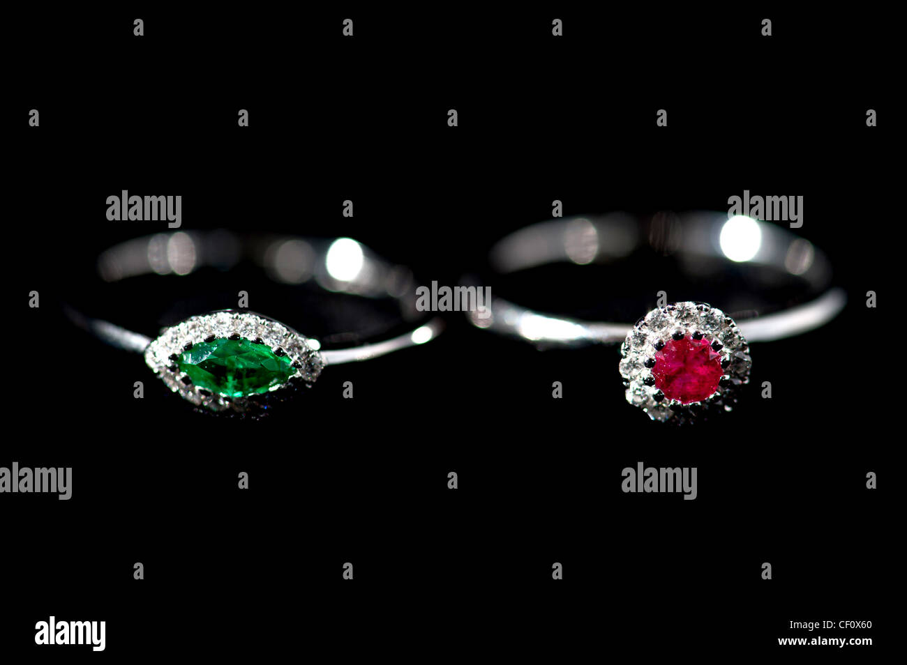 Ruby and emerald ring with diamonds soft focus Stock Photo