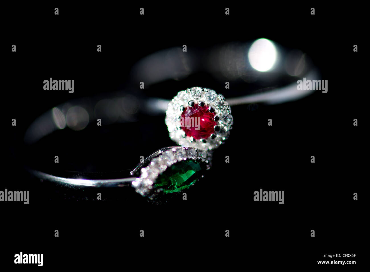 Ruby and emerald ring with diamonds soft focus Stock Photo