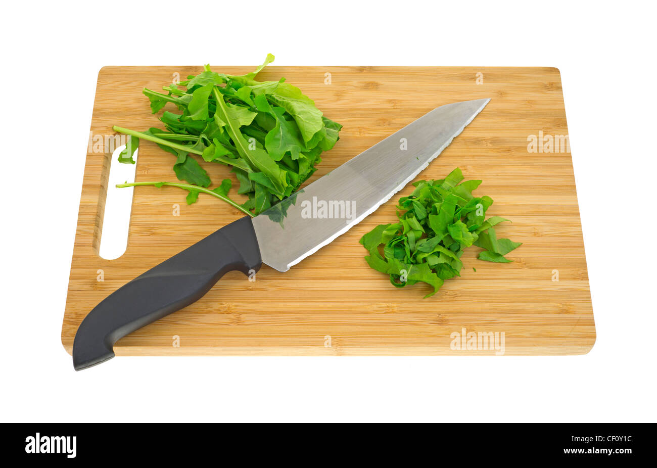 Chopped arugula on cutting board Stock Photo