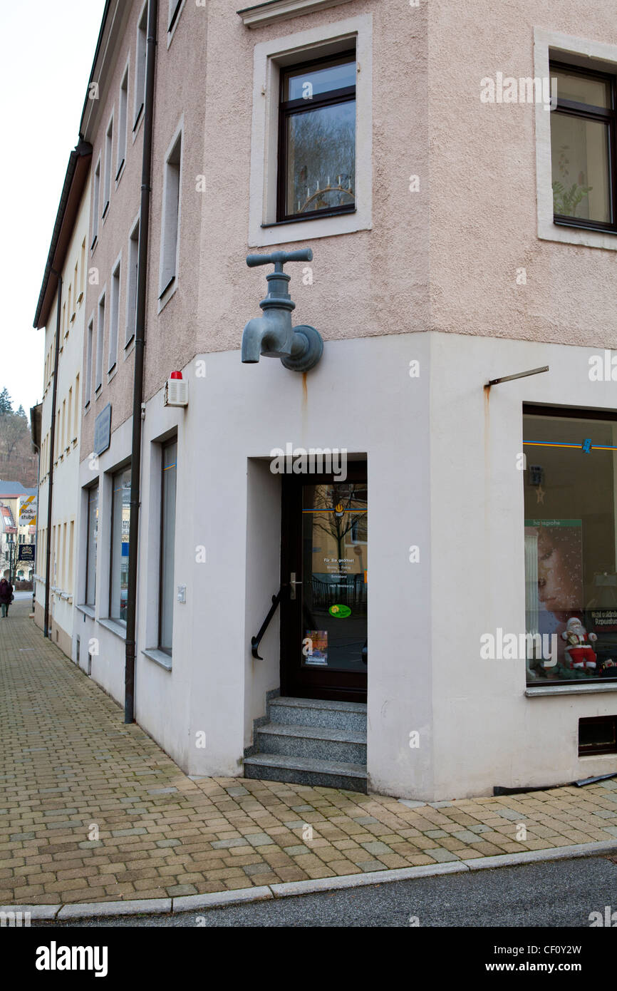 A plumbers shop in Germany with an over-sized tap as part of it's signage Stock Photo