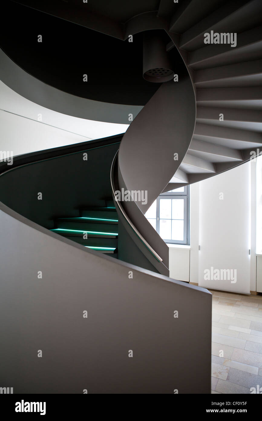 Modern spiral staircase inside a minimalist interior. Stock Photo